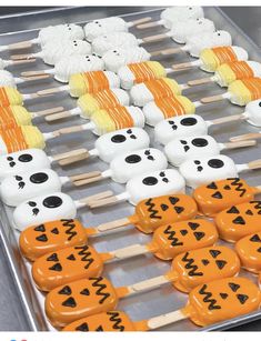 halloween treats are arranged on sticks in the shape of jack - o'- lanterns