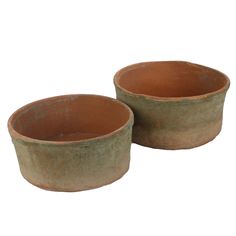 two clay bowls sitting next to each other