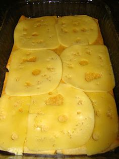 there are many pieces of food in the pan on the stove, and one is cut into cubes