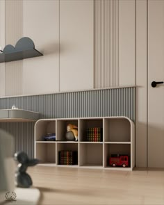 a toy firetruck sitting on top of a wooden floor next to a shelf filled with books