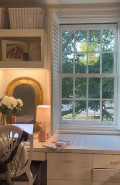 a white desk and chair in front of a window