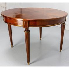 an oval dining table with two leaves on each end