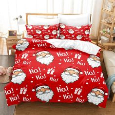 a bed with santa claus on it and red sheets that say ho ho hoo