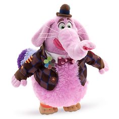 a pink stuffed animal wearing a top hat and tie with the words available in german