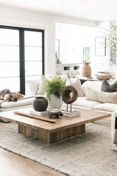 a living room filled with furniture and a wooden coffee table