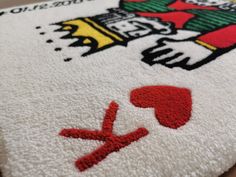 a close up view of a towel with the logo on it and an image of a hand holding a baseball bat