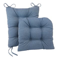 two blue cushions sitting next to each other