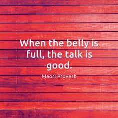 a red wooden wall with the quote when the belly is full, the talk is good