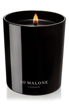 a candle that is sitting in front of a white background with the words jo malone on it