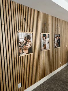 a wooden wall with pictures hanging on it