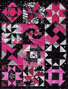 a pink and black patchwork quilt with white dots on the bottom, which has an abstract design