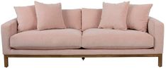 a light pink couch with six pillows on the back and two arms, sitting against a white background