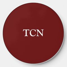 a red and white clock with the word tcn on it's front face