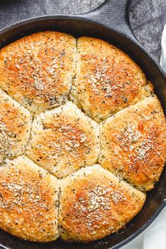 a cast iron skillet filled with bread and topped with parmesan sprinkles