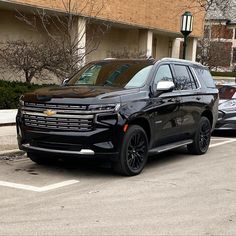 a black suv is parked in the parking lot