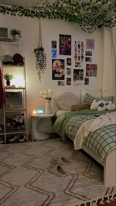 a bed room with a neatly made bed and pictures on the wall next to it