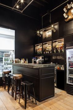 an empty bar with stools in front of it