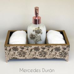 a bottle and two white towels in a wooden box