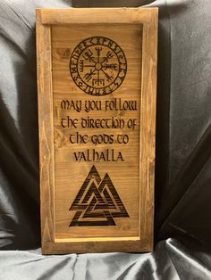 a wooden plaque with the words may you follow the direction of the gods to valila