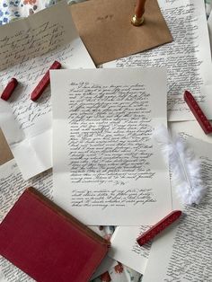 many letters are on top of each other and one has a feather quill in it