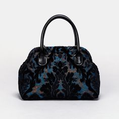 Embrace timeless elegance with our exquisite Victorian Carpet Satchel, a masterpiece meticulously crafted from rich burnout velvet for a luxurious and sophisticated touch. Designed with unique construction, this handbag stands on its own, effortlessly blending style with functionality. Crafted for enduring quality, the bag features genuine leather handles and a sturdy, heavy cotton canvas lining. Each purchase includes a detachable and adjustable shoulder strap, generously measuring 55 inches in length. The strap is skillfully crafted from the same chenille as the bag, and adorned with high-quality bronze hardware for added charm. Perfectly sized for everyday use, our handbag offers ample space to carry your essentials with ease. Stay organized with one zippered pocket, precisely sized at Carpet Bag Purse, Victorian Carpet, Goth Things, Traditional Carpet, Burnout Velvet, Carpet Bag, Black Carpet, Bronze Hardware, Mary Poppins