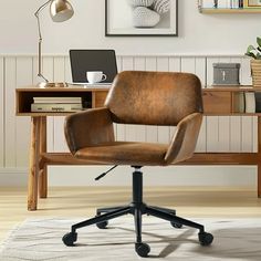 a brown leather office chair sitting in front of a desk with a laptop on it