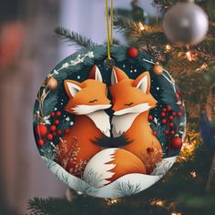 a christmas ornament with two foxes on it