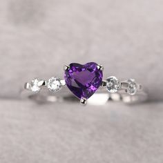 ◆ The ring is handcrafted from sterling silver and decorated with a dazzling 6*6 mm natural amethyst and tiny CZs. It is suitable for engagement/anniversary/daily occasion. ◆ Production Description: Main stone Type: Natural amethyst Main Stone Shape: Heart cut Main Stone Size: 6*6 mm(0.76ct) Side stone: CZ Metal: 925 Sterling silver - Other options available in the drop down menu ◆ Customization: √Free for Add Engraving √Other Metal Type Available √Other Gemstones & Shapes Available √Persona Silver Heart Rainbow Topaz Heart Rings Simple, Elegant Purple Heart Promise Ring, Elegant Purple Heart Ring For Anniversary, Fine Jewelry Heart Cut Amethyst Ring, Fine Jewelry Amethyst Ring Heart Cut, Elegant Purple Heart Cut Amethyst Ring, Purple Heart Cut Amethyst Ring For Anniversary, Fine Jewelry Purple Rings With Brilliant Cut, Elegant Heart Cut Purple Amethyst Ring