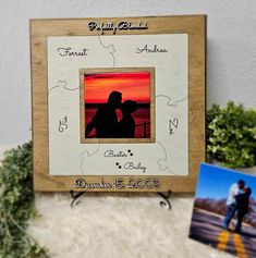 a wooden frame with a couple's photo on it