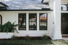 a white house with black doors and windows