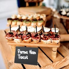 a wooden table topped with lots of different types of food on top of each other