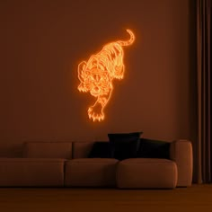 a living room with a couch and a neon tiger wall decal