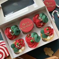 cupcakes decorated with green and red icing in a box