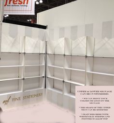 an exhibit booth with white shelving on display