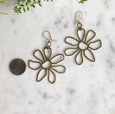 These brass earrings are surprisingly lightweight and hang beautifully. Nickel-free Brass Earrings For Summer, Brass Drop Earrings With Flower Charm, Metal Flower Charm Earrings For Spring, Brass Dangle Flower Earrings, Brass Flower Charm Earrings, Nickel Free Metal Earrings For Spring, Nickel-free Metal Earrings For Spring, Metal Flower-shaped Earrings For Spring, Pierced Metal Earrings For Spring