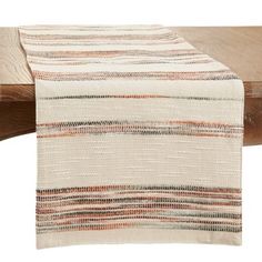 the table runner is made from woven fabric and has an orange stripe pattern on it