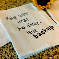 two napkins that have been placed on top of each other with the words being sisters means you always have backup up