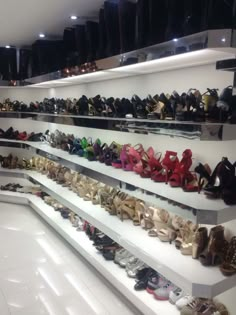 there are many pairs of shoes on the shelves