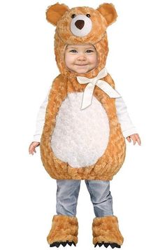 a little boy dressed in a teddy bear costume