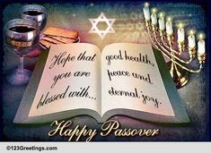 an open book with candles on it and the words happy passover written in hebrew