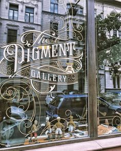 a store window with an ornate glass sign on it's front and the words department gallery written in cursive writing