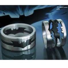 two rings with batman symbols on them, one in silver and the other in black