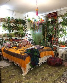 a bed room with a neatly made bed and lots of plants