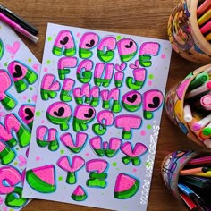 the letters and numbers are made up of pink, green, and blue shapes with dots on them