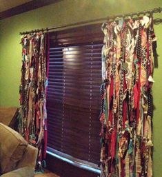 a living room filled with lots of different types of scarves on the windowsill