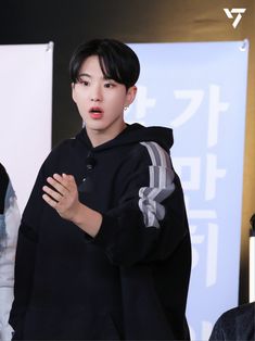 a young man standing in front of a microphone