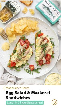 an egg salad and mackerel sandwiches on a plate with potato chips next to it