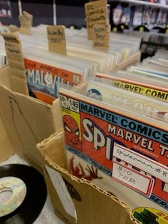 there are many comic books on display in the store and one has a vinyl record