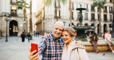 an older couple taking a selfie in the city