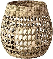 a wicker basket with candles inside on a white background for use as a candle holder